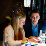 Young professionals play with light table.
