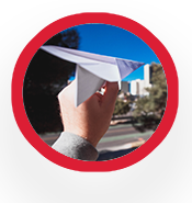 Paper airplane held up by a person's hand.