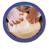 circle-slime1 Pair of hands press into blob of dough.